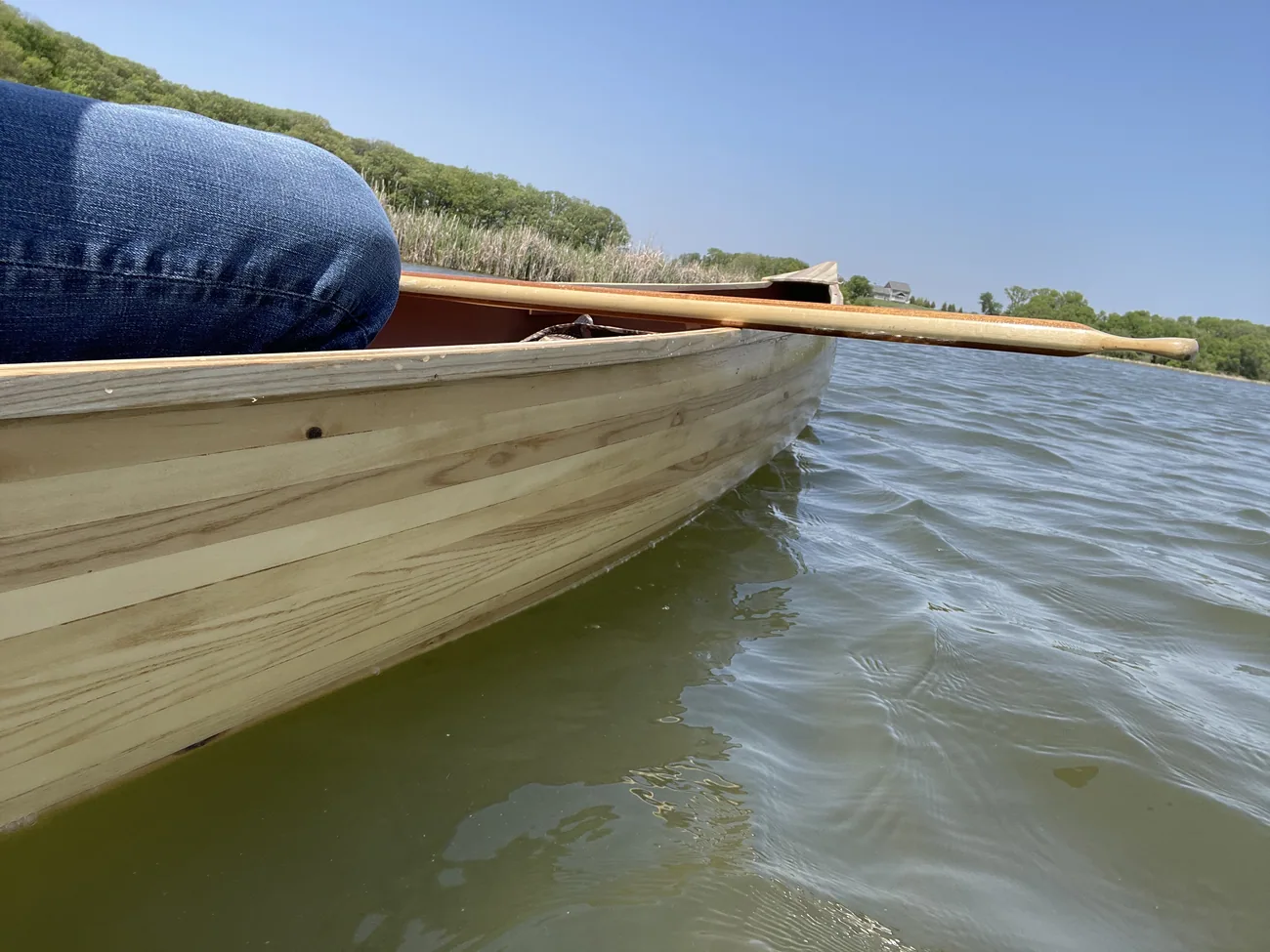 The bow of the canoe underway on open water